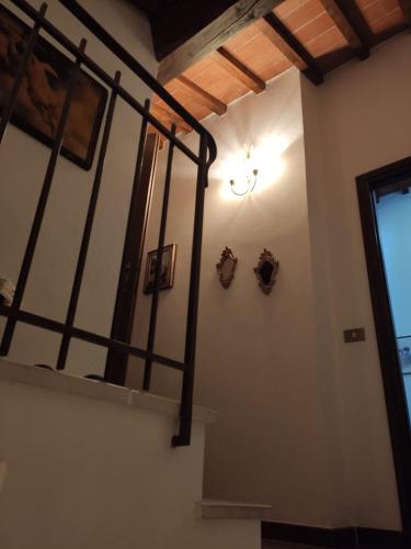 a staircase in a building with a light on the wall at Casa vacanze IL NIDO in Gualdo Tadino