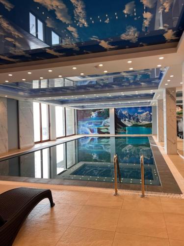 a swimming pool in the middle of a building at PresidentKop LUX Wellness & SPA Apartments in Kopaonik
