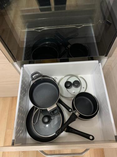 a drawer with some pots and pans in it at Alytus Apartament in Alytus