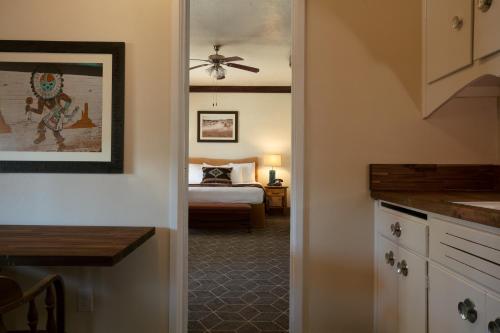 a hallway leading to a bedroom with a bed at Hotel El Rancho in Gallup