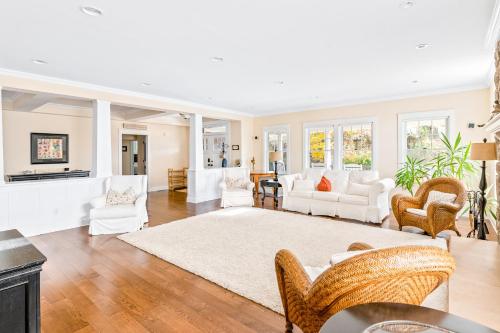 a living room with white furniture and a white rug at Beach Blessing in Montauk