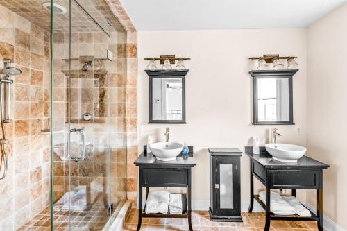 a bathroom with two sinks and a shower at Beach Blessing in Montauk
