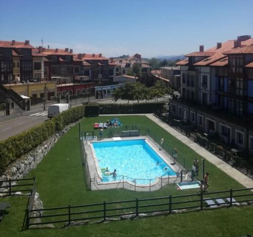 a large swimming pool in the middle of a city at Apartamento Colombres in Colombres