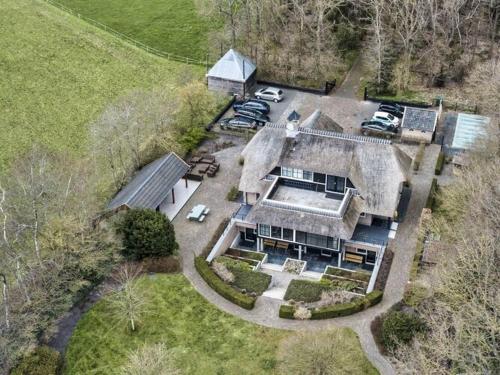 an aerial view of a large house with cars parked in the yard at Mansion in Nijensleek with Sauna & Garden in Nijensleek