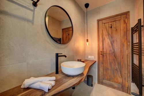 a bathroom with a sink and a mirror at KOKICHE 4 Friends, Borovets in Borovets