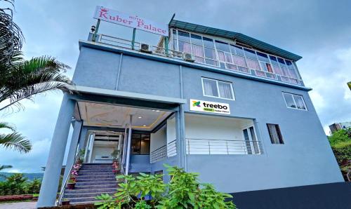 a blue building with a sign that reads kiter palace at Treebo Trend Kuber Palace in Mahabaleshwar