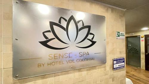 a sign on a wall with a lotus sign on it at Hotel Boutique & Spa - VDL Colonial in Villa de Leyva