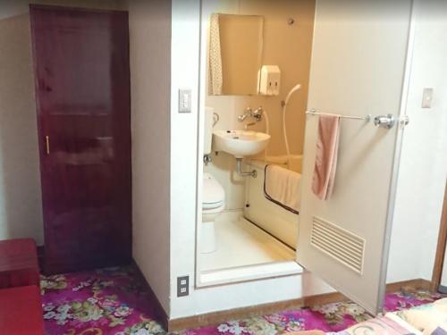 a small bathroom with a toilet and a sink at Hotel Bayside Mihara - Vacation STAY 00520v in Mihara