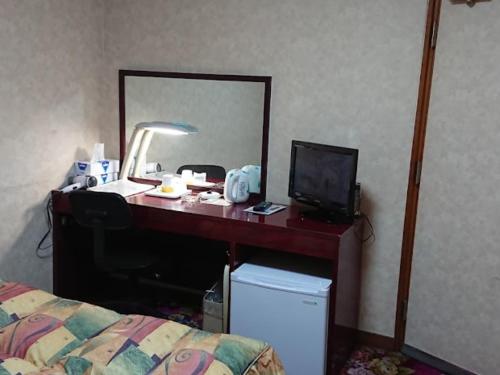 a desk in a hotel room with a television at Hotel Bayside Mihara - Vacation STAY 00529v in Mihara