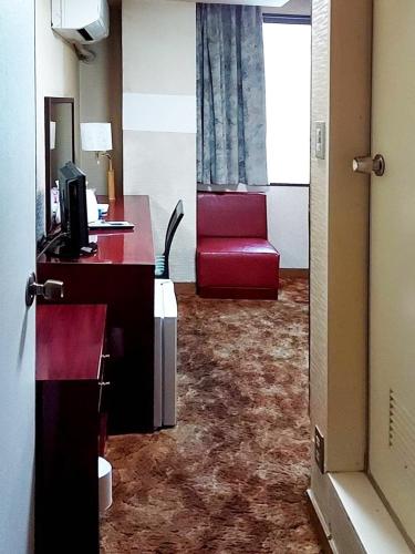 a hotel room with a desk and a red couch at Hotel Bayside Mihara - Vacation STAY 00529v in Mihara