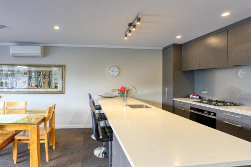 a kitchen with a table and a counter top at Marsden Lake Resort Central Otago in Cromwell