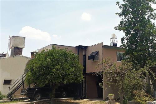 a house with a car parked in front of it at Departamento EcoSolar in Reyes