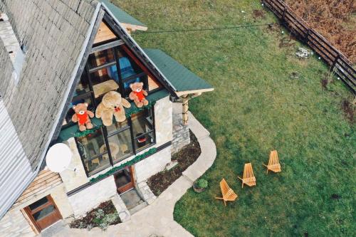 two teddy bears on the balcony of a house at Planinska Koliba ABA-TARA in Bajina Bašta