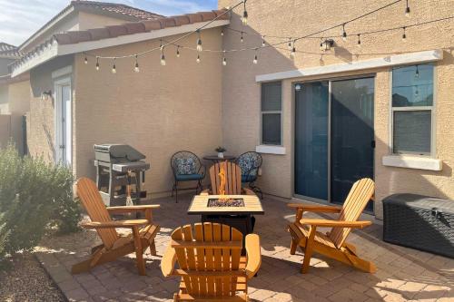 a patio with chairs and a table and a grill at Goodyear Escape with Grill Community Pool Access! in Goodyear