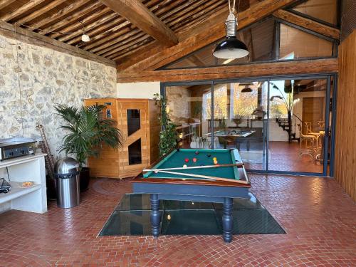 a pool table in the middle of a room at La Remise Penthouse in Le Somail