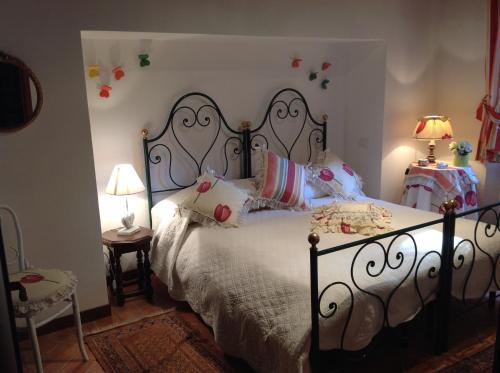 a bedroom with a bed and two tables and two lamps at Appartamento Michelangeli-Private parking in Orvieto