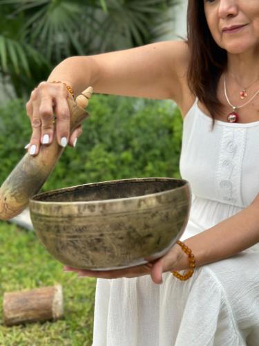 a woman in a white dress holding a metal bowl at Dos Patios Querétaro Curamoria Collection in Querétaro