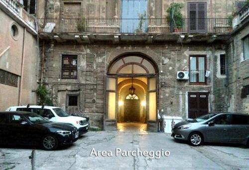 an entrance to a building with cars parked in front of it at Palazzo Galati Palermo in Palermo