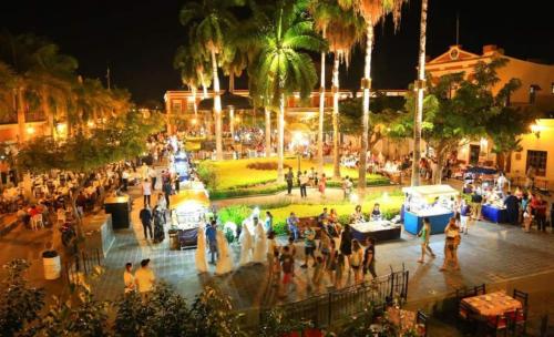 uma multidão de pessoas em torno de um parque à noite em Casa Sixto Osuna Boutique em Mazatlán
