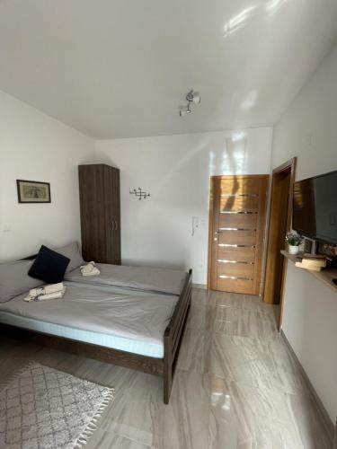 a bedroom with a bed and a television in it at Apartman Gakić 2 in Nova Varoš