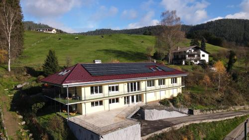 a house with solar panels on top of a hill at Ferienhaus Lacher in Baiersbronn