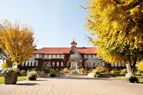 a large building with trees in front of it at St. Eugene Golf Resort & Casino in Cranbrook