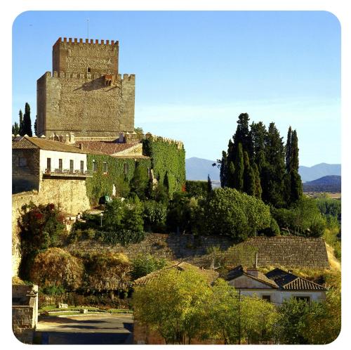 a castle on top of a hill with trees at Parador de Ciudad Rodrigo in Ciudad-Rodrigo