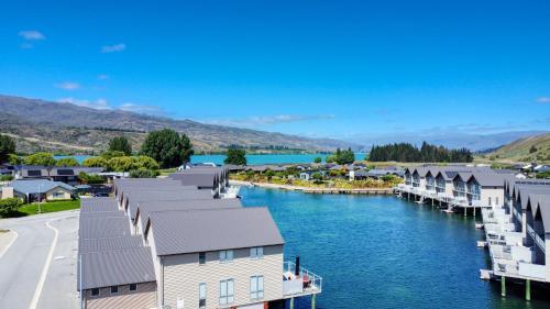 arial view of a town on a river with houses at Marsden Lake Resort Central Otago in Cromwell