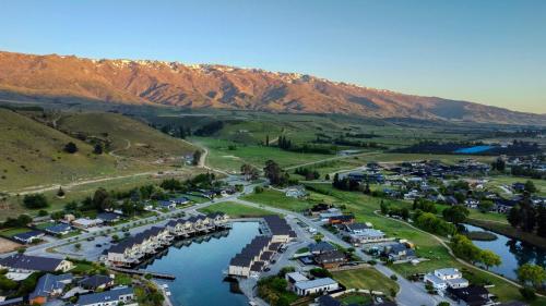 an aerial view of a town with a river and mountains at Marsden Lake Resort Central Otago in Cromwell