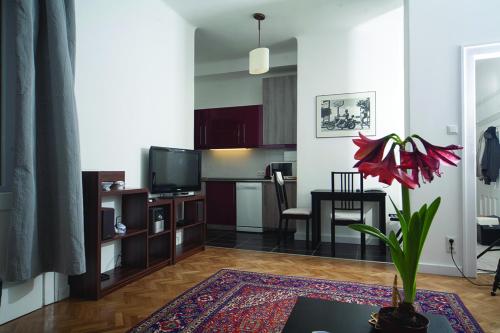 a living room with a vase with a flower on a table at Judy and Sandor Apartmen in Budapest