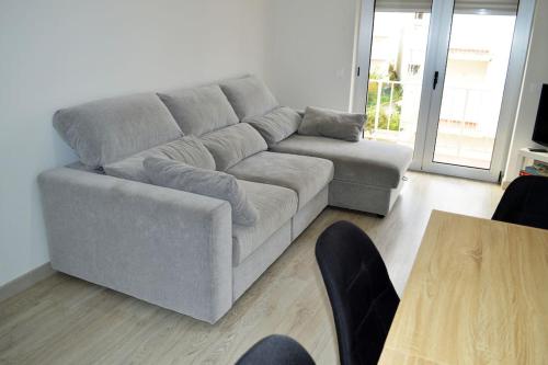ein Wohnzimmer mit einem grauen Sofa und einem Tisch in der Unterkunft Market Apartment - VPA in Vila Praia de Âncora