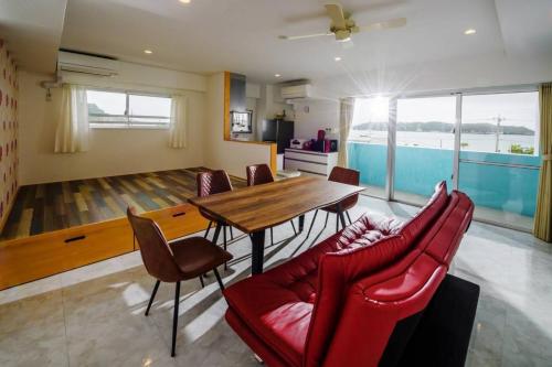 a kitchen and dining room with a wooden table and chairs at Guest room WES - Vacation STAY 49860v in Uruma