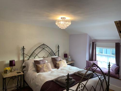a bedroom with a bed and a chandelier at Evangelisa in Lampeter