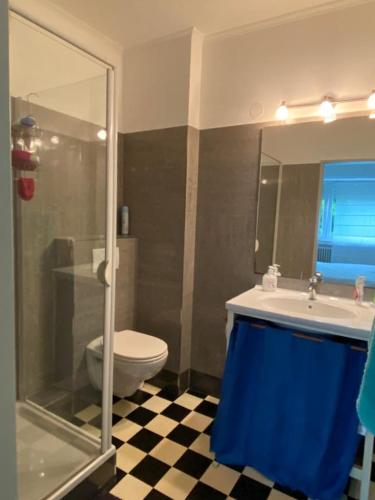 a bathroom with a toilet and a sink and a shower at Green House Strassen in Strassen
