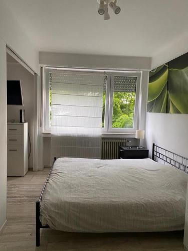 a bedroom with a large bed and a window at Green House Strassen in Strassen