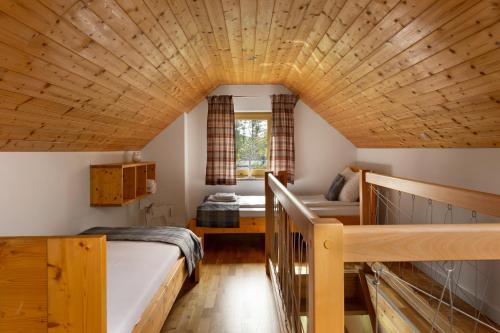 a bedroom with a bed and a staircase in a house at Apartamenty u Harrego II Przy Stawie Spa klimatyzacja,balkon,sauna , balia, ogród,parking in Kudowa-Zdrój