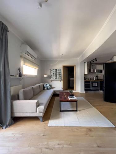 a living room with a couch and a table at Homevision - Stylish & Serene Condo - City Center in Thessaloniki