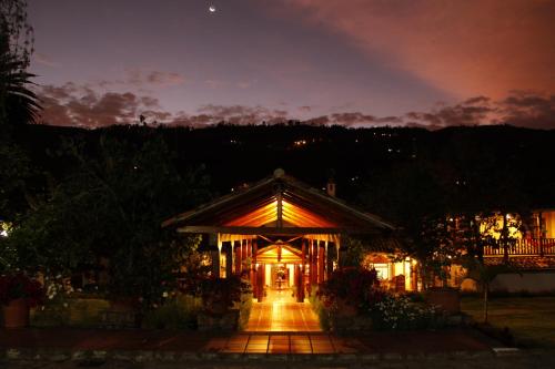 a lit up building at night with a sky at Uzhupud Garden Hotel & Lodge in Paute