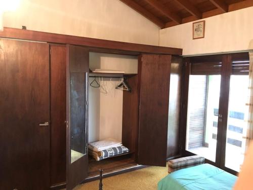 1 dormitorio con armario, cama y ventana en Casa 3 ambientes 3 baños en Mar del Plata