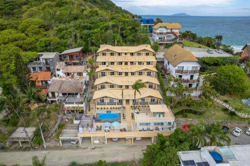 an aerial view of a house on the beach at Pousada Vila do Navegante in Bombinhas