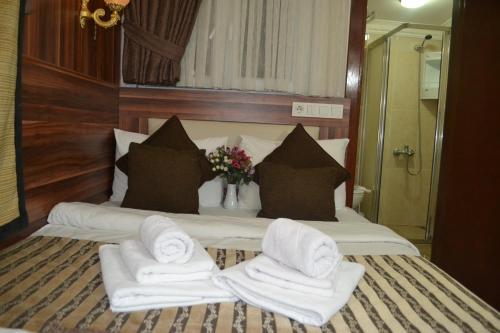 a bedroom with a bed with towels on it at Grand Fatih Hotel in Istanbul