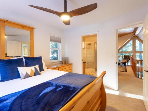 a bedroom with a bed and a ceiling fan at Yverin Muse Cabin in Glacier