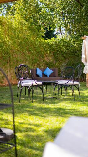 a table and chairs sitting in the grass at Riad villa saphir & SPA in Marrakech