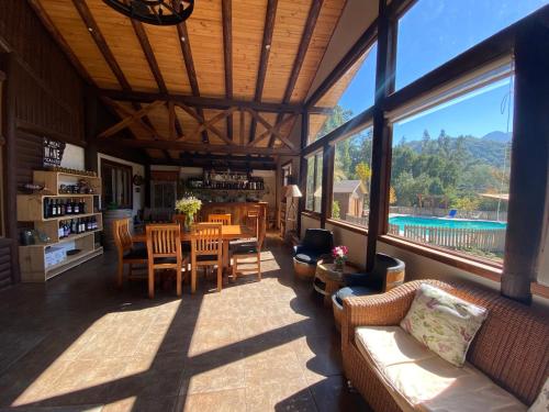 a large living room with a table and chairs at Tumuñan Lodge in El Llano
