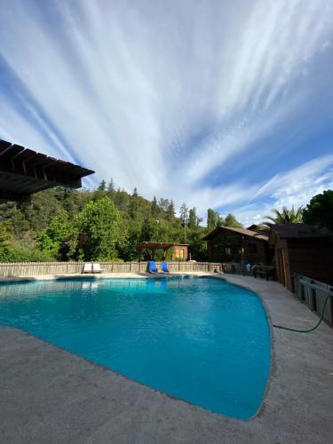 a large blue swimming pool in a yard at Tumuñan Lodge in El Llano