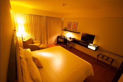 a hotel room with a bed and a television at Pestana Caracas Premium City & Conference Hotel in Caracas