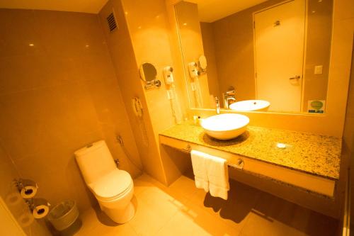 a bathroom with a sink and a toilet and a mirror at Pestana Caracas Premium City & Conference Hotel in Caracas