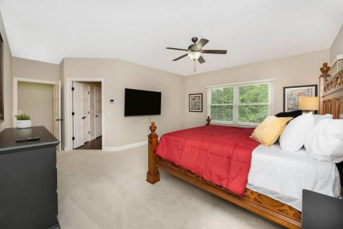 a bedroom with a bed and a flat screen tv at 5755 Butler Warren Cheerful 6-Bedroom Villa with fishing pond in Jericho
