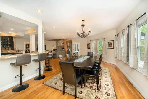 a dining room with a table and chairs at 5755 Butler Warren Cheerful 6-Bedroom Villa with fishing pond in Jericho