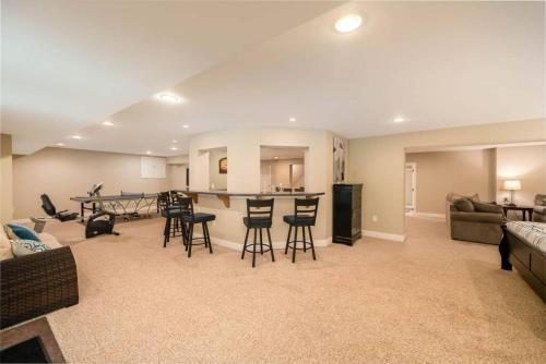 a living room with a couch and a table and chairs at 5755 Butler Warren Cheerful 6-Bedroom Villa with fishing pond in Jericho